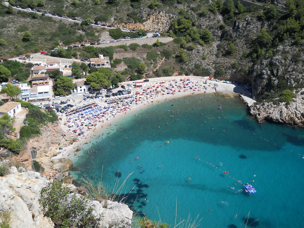 Vista de Cala Granadella con kayaks y bañistas en sus aguas turquesas